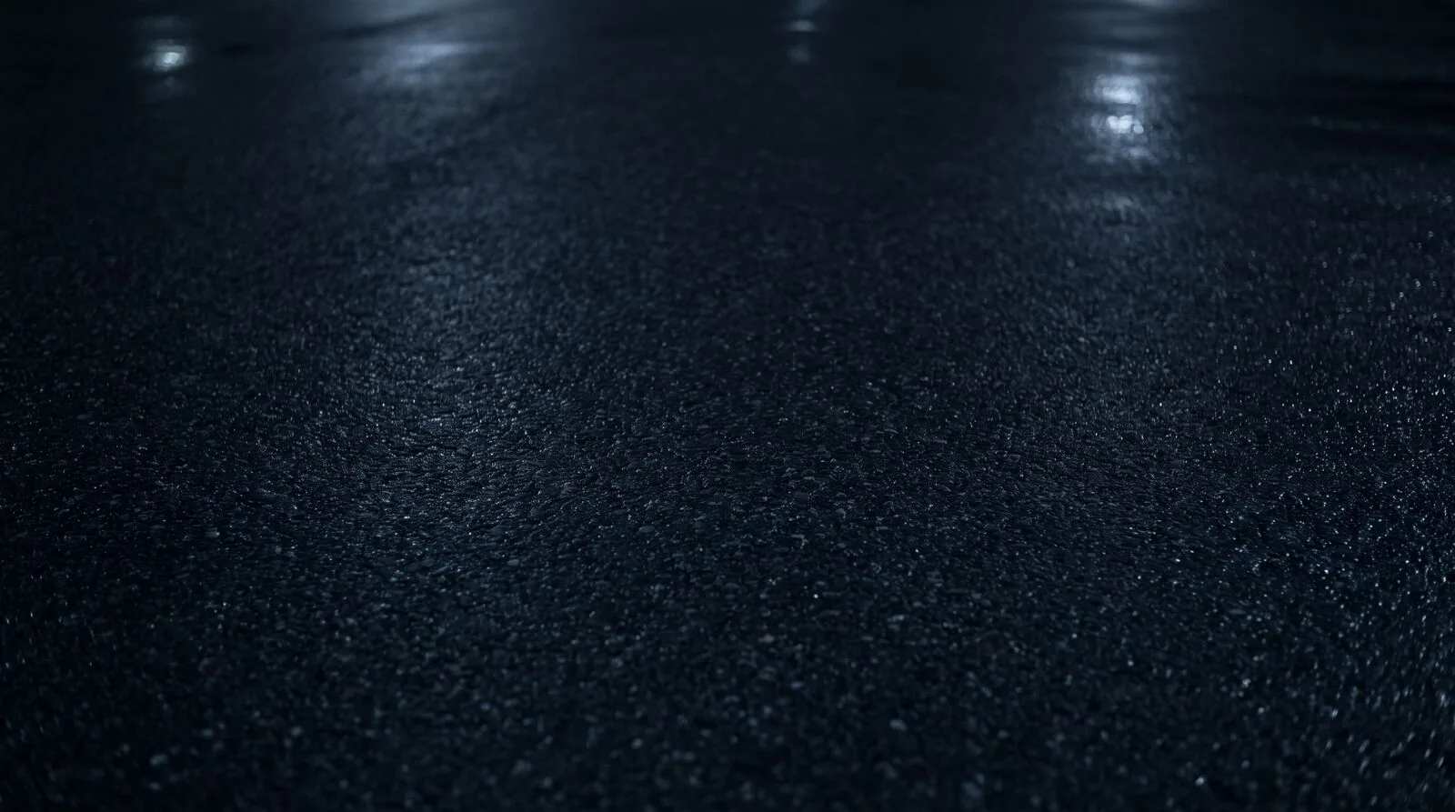 Asphalt road surface at night